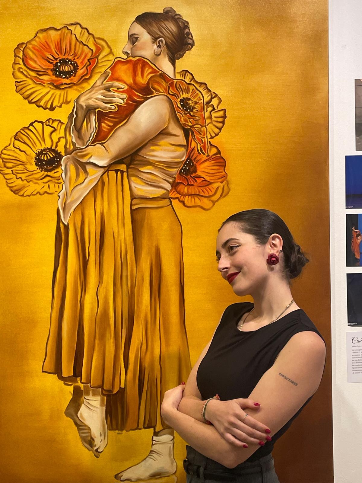 Alba Moreno Rovira beside one of her paintings